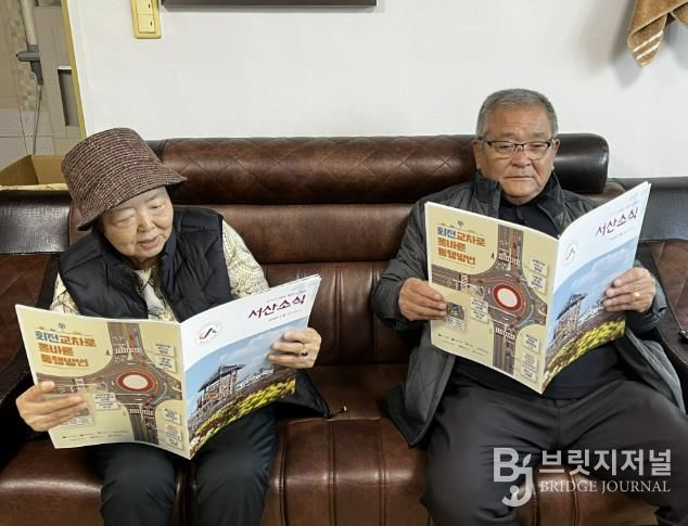 경로당에서 어르신이 큰 글자 서산소식을 읽는 모습