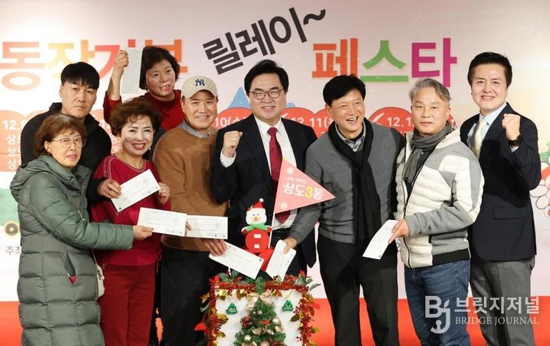 박일하 동작구청장이 지난해 12월 개최된 동작기부릴레이페스타에 참여한 주민들과 함께 기념 촬영을 하고 있다